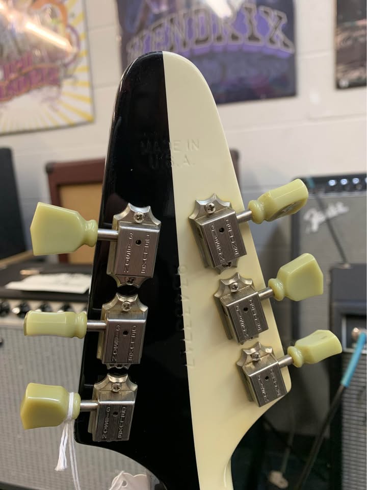 Back of the split-color headstock and tuning machines on the second guitar