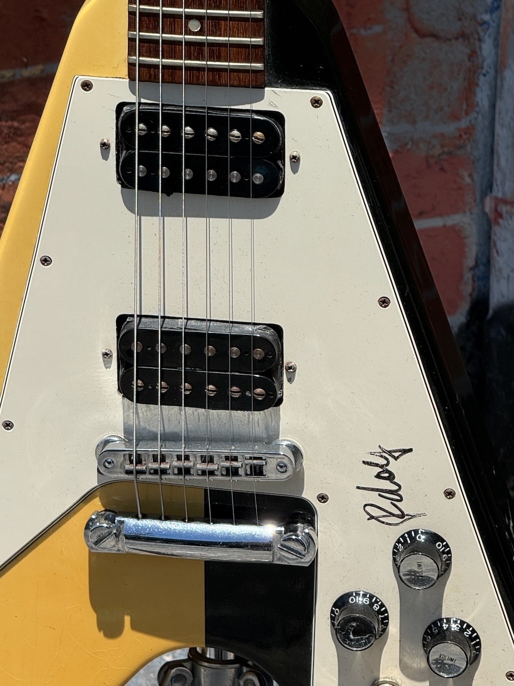 Close view of the guitar body and signed pickguard