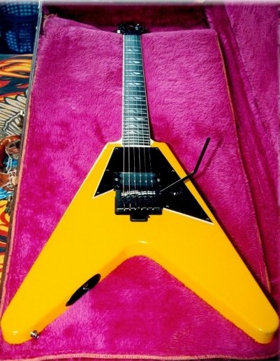 Yellow single-pickup Gibson V90 showing its jack socket and tremolo